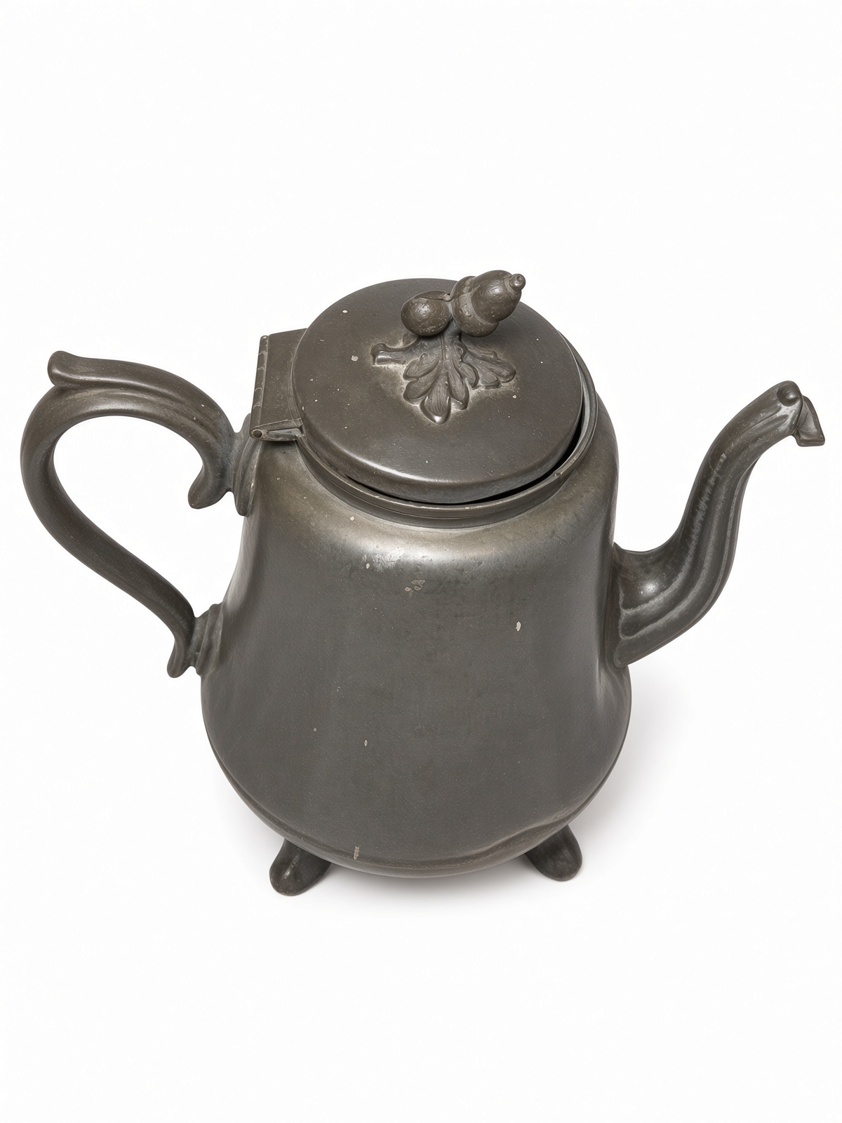 Three-quarter view of the same pot, showing the hinged lid and original double-acorn-on-oak-leaves finial